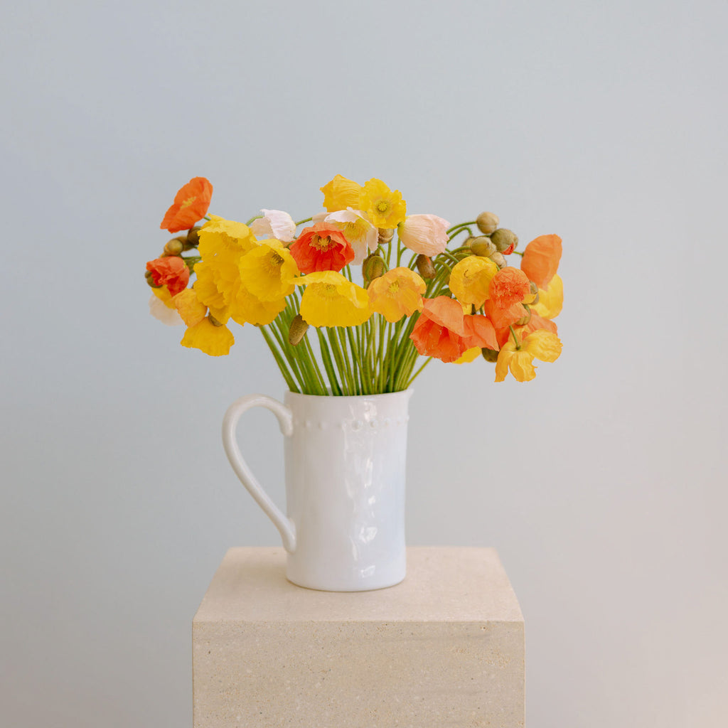 Bright colurful posies in a jug