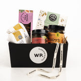 Gift basket with various products including jars and packets, branded with 'WP' and 'Floristikke Gifts'.