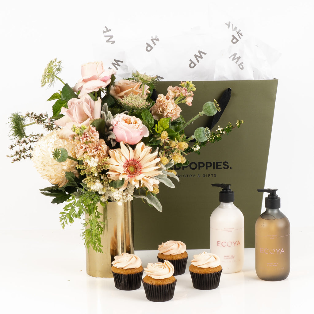 "Just Because" Gift Set featuring a fresh pastel posy, four petal cupcakes, and luxurious Ecoya hand and body care products. Elegantly presented in a premium Wild Poppies gift bag with tissue paper and satin ribbon, perfect for brightening someone's day with thoughtful indulgence.