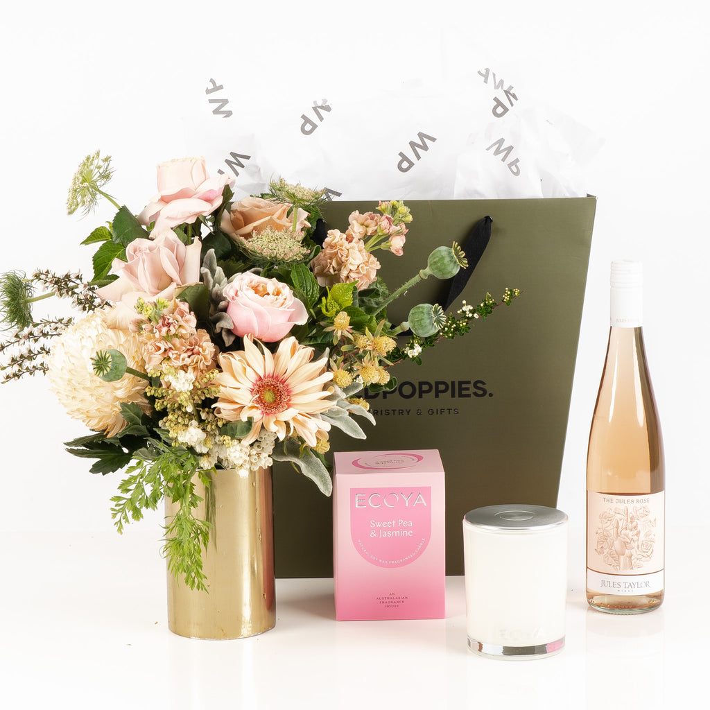 "Sweet Jules Gift Set" featuring a fresh pastel posy, a bottle of Jules Taylor The Jules Rosé, and an Ecoya Sweet Pea and Jasmine scented candle. Elegantly presented in a premium Wild Poppies gift bag with tissue paper and satin ribbon, this luxurious set is perfect for any occasion that calls for celebration and indulgence.